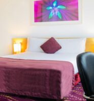 Cosy hotel room with purple accents and modern decor at Louis Fitzgerald Hotel, Dublin.
