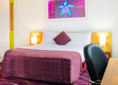 Cosy hotel room with purple accents and modern decor at Louis Fitzgerald Hotel, Dublin.