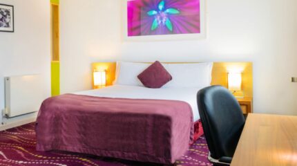 Cosy hotel room with purple accents and modern decor at Louis Fitzgerald Hotel, Dublin.