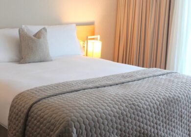 Elegant hotel room with cosy lighting and plush bedding.