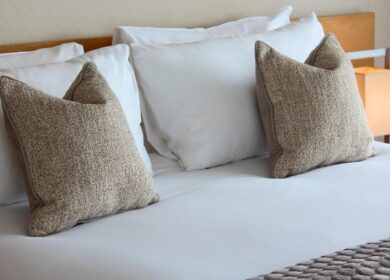 A cosy bed with soft pillows in a luxury hotel room at Louis Fitzgerald Hotel, Dublin.