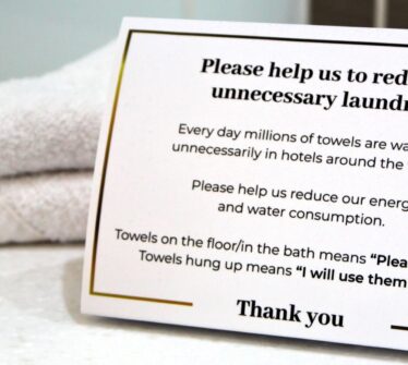 Sustainable towel initiative sign at Louis Fitzgerald Hotel, Dublin.