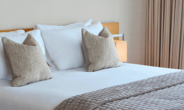 Elegant hotel room with plush pillows and quilted bedding at Louis Fitzgerald Hotel, Dublin.
