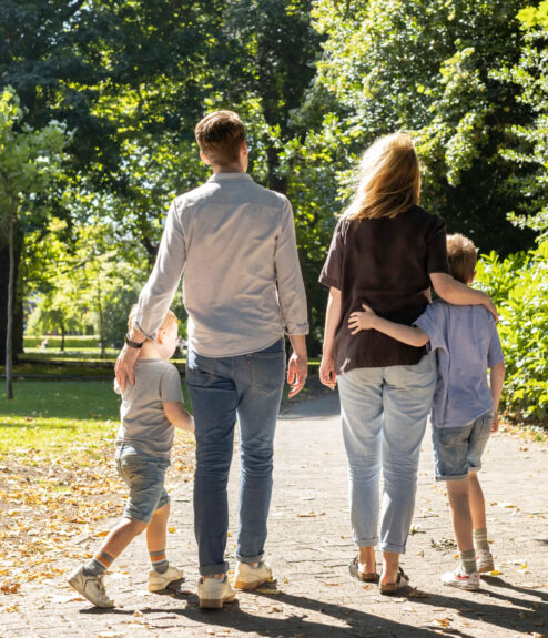 Family walking in a sunlit park, enjoying a peaceful stroll near Dublin.