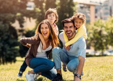 Happy family enjoying a sunny day outdoors on the hotel grounds.