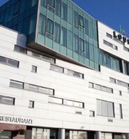 Modern exterior of Louis Fitzgerald Hotel with LJ's Bar & Restaurant signage.
