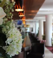 Elegant hotel lobby with floral decor and ambient lighting.