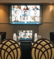 Elegant conference room setup at Louis Fitzgerald Hotel with virtual meeting display.