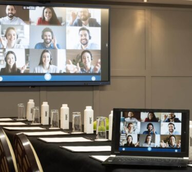 Modern meeting room with virtual conference setup at Louis Fitzgerald Hotel in Dublin.