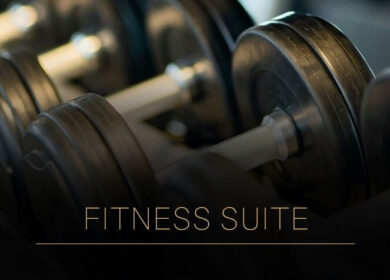 Close-up of dumbbells with "Fitness Suite" text at the Louis Fitzgerald Hotel.