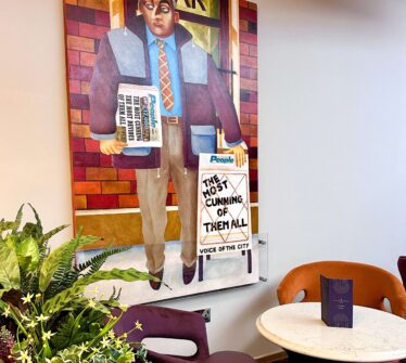 Stylish lobby corner at Louis Fitzgerald Hotel, featuring vibrant artwork and cosy seating.