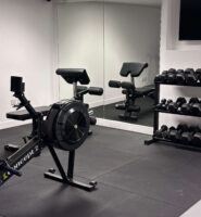 Modern gym with exercise equipment and mirrors at Louis Fitzgerald Hotel, Dublin.
