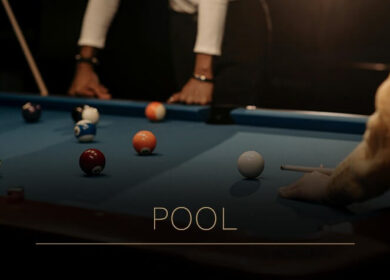 Guests enjoy a game of pool in a cosy, dimly lit room at Louis Fitzgerald Hotel, Dublin.