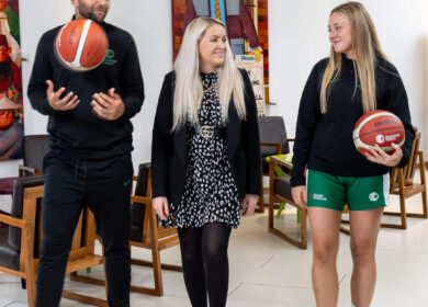 Hotel guests enjoying a conversation in the stylish lobby, holding basketballs.