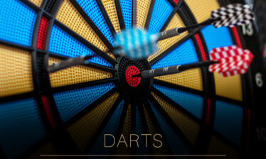Darts stuck in a colourful dartboard at Louis Fitzgerald Hotel.