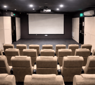 Luxurious private cinema room with plush seating at Louis Fitzgerald Hotel, Dublin.