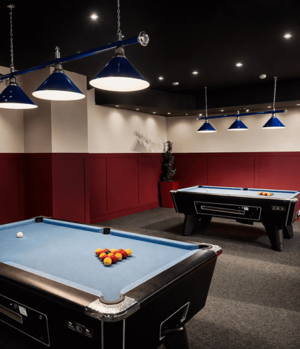 Pool tables in a stylish games room with blue lights at Louis Fitzgerald Hotel, Dublin.