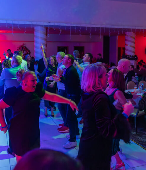 Guests dancing and enjoying a vibrant evening event at Louis Fitzgerald Hotel.