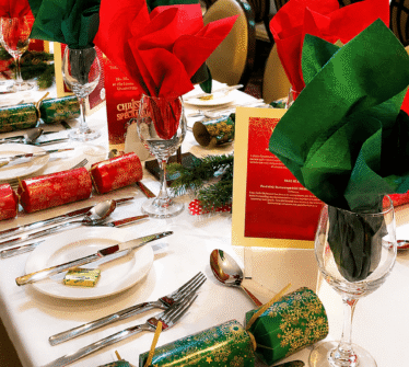 Festively decorated dining table with Christmas crackers at Louis Fitzgerald Hotel, Dublin.